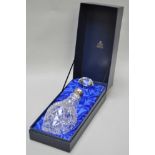 A boxed Garrard cut glass decanter with silver collar,