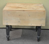 A drop leaf pine table, raise on painted turned legs,