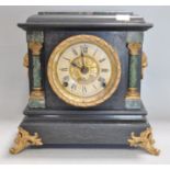 A Victorian mantel clock, in blackened marble, with lion mask handles,