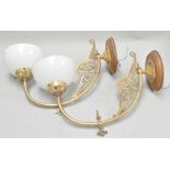 A pair of brass wall lights with opaque shades,