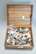 A wooden box containing buttons and other items