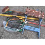 A collection of garden tools, to include a work bench, saws, brushes,