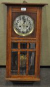 An oak cased wall clock,