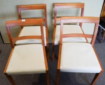 A set of four chairs with faux leather seats,