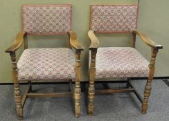 A pair of oak armchairs with upholstered tapestry backs and seats and turned legs and arms,