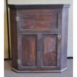 A stained oak corner cupboard,