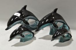 Four Poole pottery dolphins