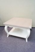 A wood coffee table, of square form, with lower shelf, in a painted finish,