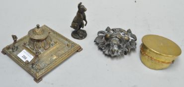 A group of brass ware, including a brass ink well,
