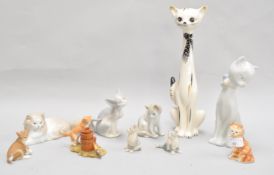 A Lladro figure of a cat and other cats, the tallest