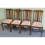 A set of four mahogany dining chairs, with carved medallion to vertical splats,