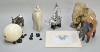 A collection of elephant related items, to include a lidded pot, a bronzed resin figure,