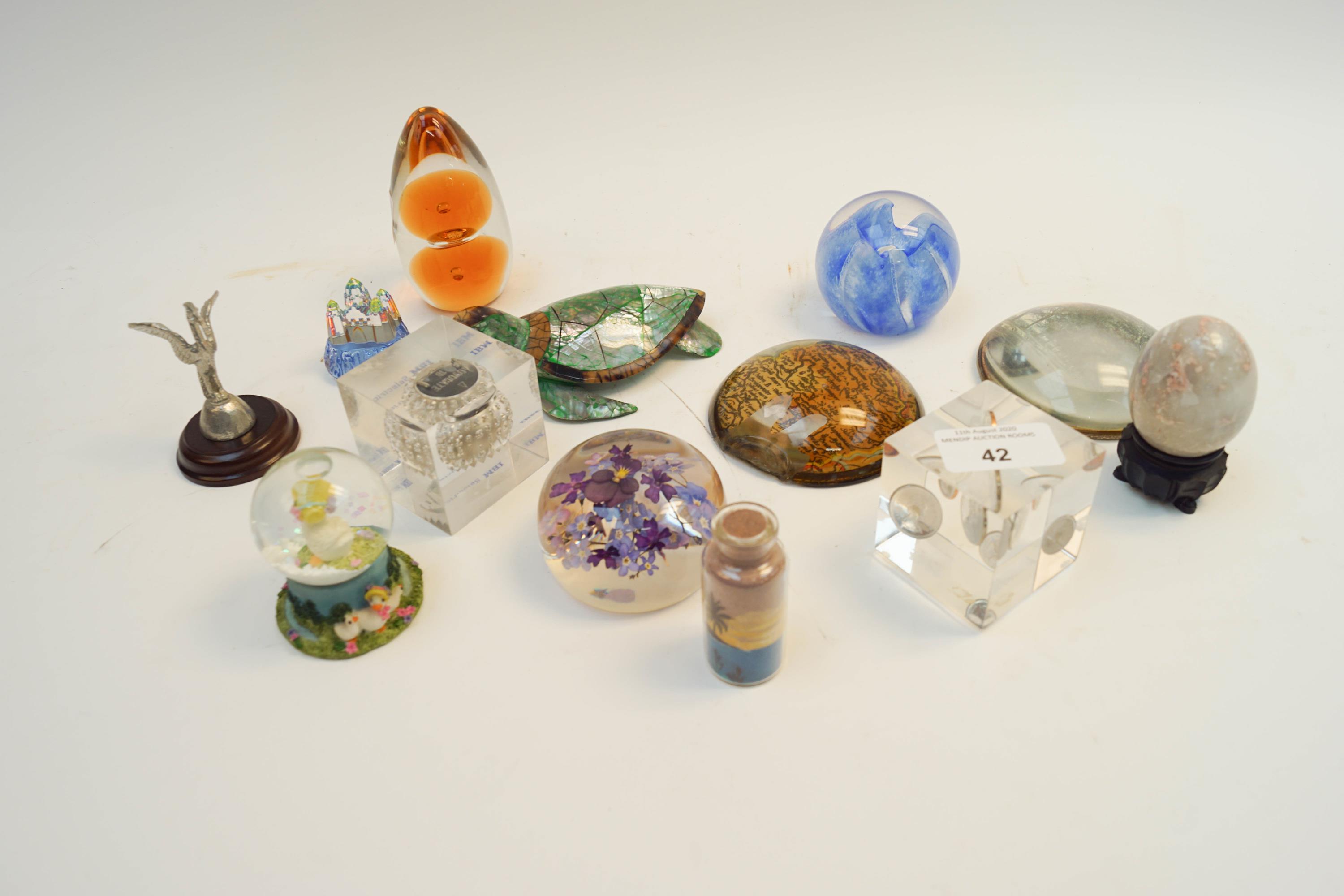 A quantity of glass and other paperweights with other items