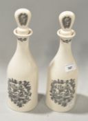 A pair of Coalport limited edition bottles with transfer print designs and stopper to top