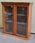 A mahogany glazed bookcase, enclosing two removable shelves,