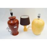 Three table lamps, in pottery and onyx,