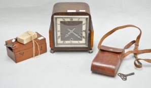 A camera in leather case, a microscope in mahogany case and an oak cased clock,