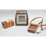 A camera in leather case, a microscope in mahogany case and an oak cased clock,