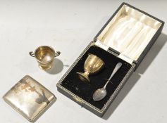 A cased silver egg cup and spoon,