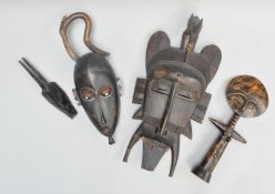 A collection of 20th century African tribal carved masks, possibly Guro tribe, largest 50cm long,