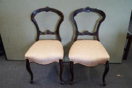 Two balloon back chairs, in mahogany on cabriole legs,