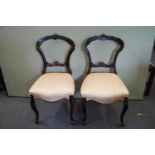 Two balloon back chairs, in mahogany on cabriole legs,