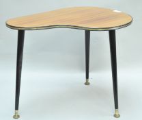 A 1970's occasional table, with shaped formica top,