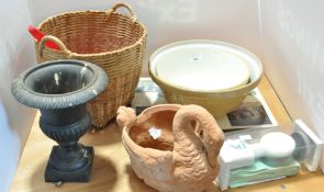 Two English pottery mixing bowls, a cast iron urn, a terracotta swan,