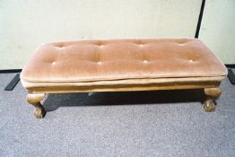 A rectangular foot stool on cabriole legs wjth ball and claw feet