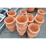 A quantity of moulded terracotta garden pots