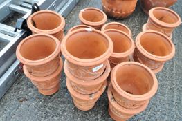 A quantity of moulded terracotta garden pots