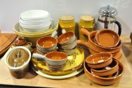 A terracotta cookware and mixing bowl