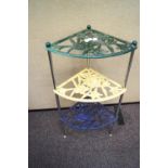 A multicoloured cast metal pot stand with floral designs