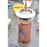 A terracotta chimney pot with a zinc cowl
