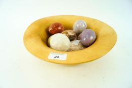 A turned horse chestnut wood bowl with nine decorative mixed mineral eggs