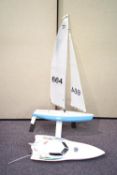 A 'Dash' racing boat remote control pond yacht with another