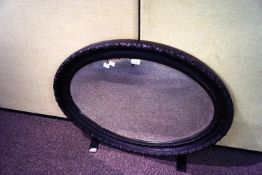 A Victorian carved oval wall hanging mirror