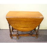 An oak drop leaf table on barley twist legs