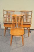 A set of three Ercol wall shelves and three stick back chairs