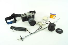 A Pentax K1000 SLR camera with accessories