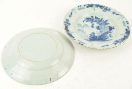 A pair of 18th century Dutch Delft plates, 1760-80, painted in blue with flowers,