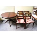 A mahogany dining table and four chairs with brass inlay