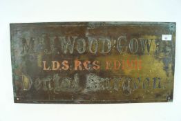 A brass wall plaque for a Dental Surgery