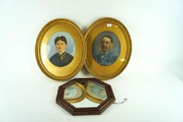 A pair of portraits in gilt frames and an oak mirror