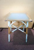 A Lloyd Loom occasional table in a blue and gold colourway