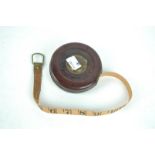 A leather cased 33ft tape measure,