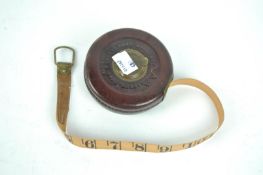 A leather cased 33ft tape measure,