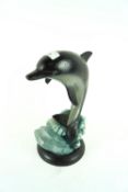 A cast iron doorstop in the form of a dolphin