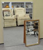 A large contemporary mirror along with a gilt acanthus leaf decorated mirror