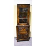 An oak Old Charm style corner cabinet